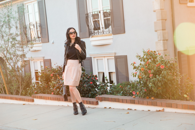 How to Dress Like a Londoner, styling tips featured by top LA fashion blog, Pretty Little Shoppers: image of a woman wearing Juicy Couture leather jacket, Alice & Olivia blouse, Anthropologie skirt, Tommy Hilfiger booties, and a Chanel bag.