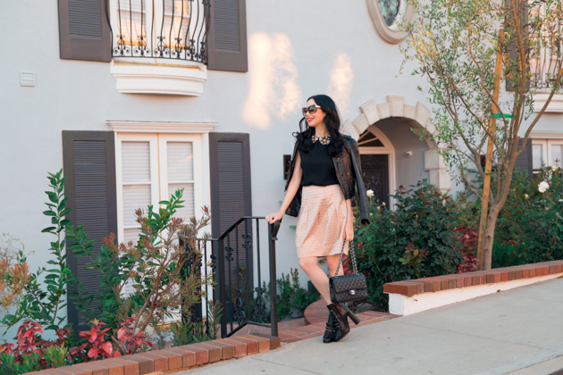 How to Dress Like a Londoner, styling tips featured by top LA fashion blog, Pretty Little Shoppers: image of a woman wearing Juicy Couture leather jacket, Alice & Olivia blouse, Anthropologie skirt, Tommy Hilfiger booties, and a Chanel bag.