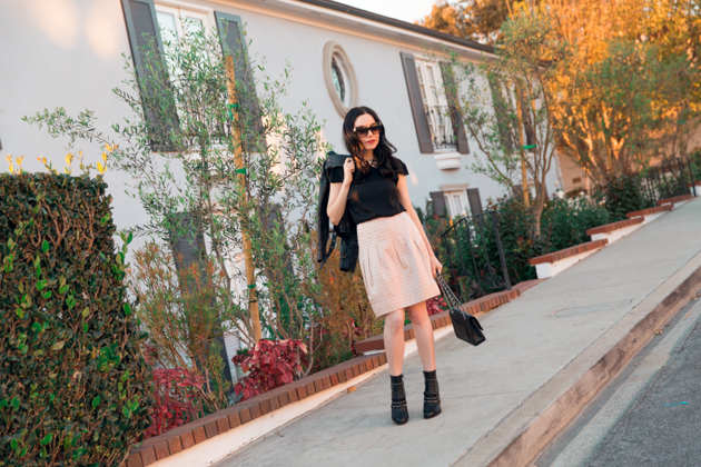 How to Dress Like a Londoner, styling tips featured by top LA fashion blog, Pretty Little Shoppers: image of a woman wearing Juicy Couture leather jacket, Alice & Olivia blouse, Anthropologie skirt, Tommy Hilfiger booties, and a Chanel bag.