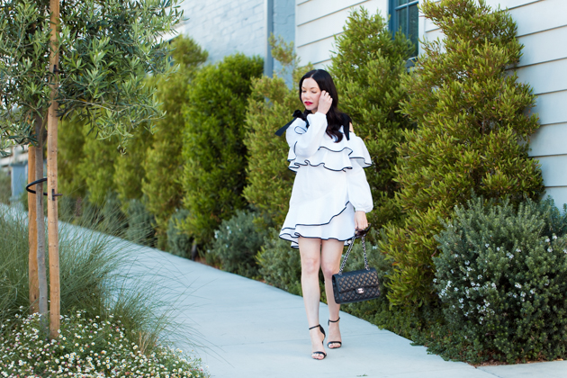 Lisa Valerie Morgan wears Petersyn Ruffled Dress, Schutz Sandals, Chanel Bag