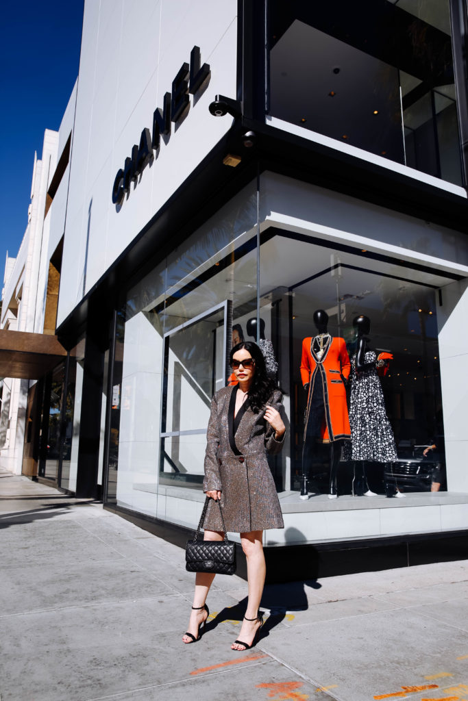 How to Style a Blazer Dress, tips featured by top LA fashion blog, Pretty Little Shoppers: image of a woman wearing a Bronx & Marco blazer dress, Steve Madden sandals, Chanel bag, and Oliver Peoples sunglasses. | How to Style A Blazer Dress, Bronx and Banco, Revolve Clothing, Nuuly, Winter Fashion, Winter Style, Shop till you drop, Fashion Influencer, Quilted Chanel Bag, Winter Trends, Who What Wearing, Fashion Blogger Style, Outfit Inspiration, Street Style, Street Fashion, OOTD Inspo, Street Style Stalking, Seasonal Style, What to Wear in Winter, Beverly Hills Style #bronxandbanco #mynuuly #fashionblogger #lafashionblogger #streetstyle #Winterfashion #parisianchic #blazerdress