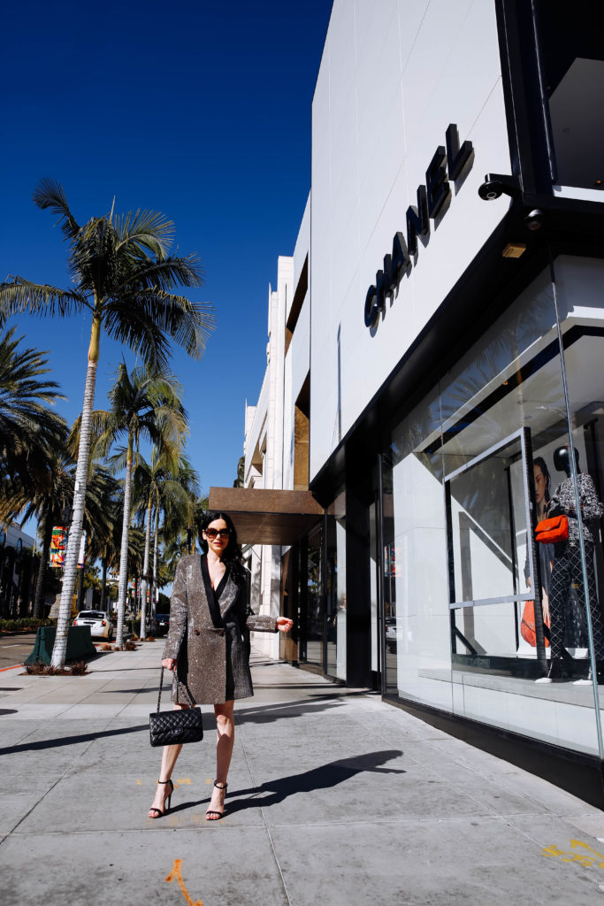 How to Style a Blazer Dress, tips featured by top LA fashion blog, Pretty Little Shoppers: image of a woman wearing a Bronx & Marco blazer dress, Steve Madden sandals, Chanel bag, and Oliver Peoples sunglasses. | How to Style A Blazer Dress, Bronx and Banco, Revolve Clothing, Nuuly, Winter Fashion, Winter Style, Shop till you drop, Fashion Influencer, Quilted Chanel Bag, Winter Trends, Who What Wearing, Fashion Blogger Style, Outfit Inspiration, Street Style, Street Fashion, OOTD Inspo, Street Style Stalking, Seasonal Style, What to Wear in Winter, Beverly Hills Style #bronxandbanco #mynuuly #fashionblogger #lafashionblogger #streetstyle #Winterfashion #parisianchic #blazerdress