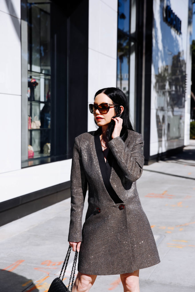 How to Style a Blazer Dress, tips featured by top LA fashion blog, Pretty Little Shoppers: image of a woman wearing a Bronx & Marco blazer dress, Steve Madden sandals, Chanel bag, and Oliver Peoples sunglasses. | How to Style A Blazer Dress, Bronx and Banco, Revolve Clothing, Nuuly, Winter Fashion, Winter Style, Shop till you drop, Fashion Influencer, Quilted Chanel Bag, Winter Trends, Who What Wearing, Fashion Blogger Style, Outfit Inspiration, Street Style, Street Fashion, OOTD Inspo, Street Style Stalking, Seasonal Style, What to Wear in Winter, Beverly Hills Style #bronxandbanco #mynuuly #fashionblogger #lafashionblogger #streetstyle #Winterfashion #parisianchic #blazerdress