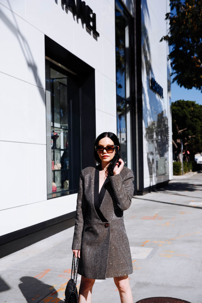 How to Style a Blazer Dress, tips featured by top LA fashion blog, Pretty Little Shoppers: image of a woman wearing a Bronx & Marco blazer dress, Steve Madden sandals, Chanel bag, and Oliver Peoples sunglasses. | How to Style A Blazer Dress, Bronx and Banco, Revolve Clothing, Nuuly, Winter Fashion, Winter Style, Shop till you drop, Fashion Influencer, Quilted Chanel Bag, Winter Trends, Who What Wearing, Fashion Blogger Style, Outfit Inspiration, Street Style, Street Fashion, OOTD Inspo, Street Style Stalking, Seasonal Style, What to Wear in Winter, Beverly Hills Style #bronxandbanco #mynuuly #fashionblogger #lafashionblogger #streetstyle #Winterfashion #parisianchic #blazerdress