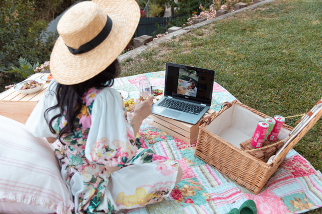 How to Host A Virtual Picnic, Quarantine Life, Things to do during Quarantine Outside, Virtual Picnic Menu, Things to do in your backyard #VirtualPicnic #SummerPicnic #QuarantineActivities Hemant and Nandita Dress, No-Mayo Potato Salad, Smoked Salmon, Gluten-Free Chocolate Chip Scones, Casa Luigi Prosecco, Pretty Little Shoppers Blog | Virtual Picnic by popular L.A. lifestyle blog, Pretty Little Shoppers: image of a woman wearing a Teien Mini Dress HEMANT AND NANDITA brand: HEMANT AND NANDITA and Amazon Lack of Color Women's The Spencer Boater Hat and sitting next to a wicker picnic basket, wooden crates, plates of food, and some Casa Luigi sparkling wine on a patchwork quilt outside. 