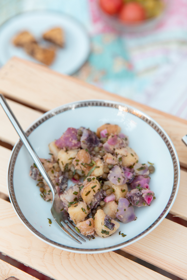 Light and Easy No-Mayo Potato Salad | Virtual Picnic by popular L.A. lifestyle blog, Pretty Little Shoppers: image of no mayo potato salad in a white ceramic bowl. 