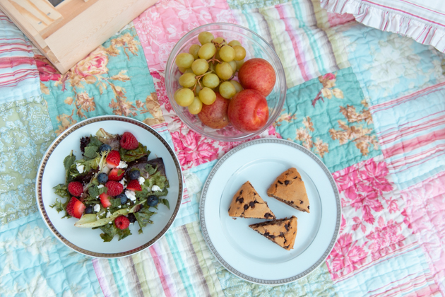 Summer Picnic Recipes, No-Mayo Potato Salad, Smoked Salmon, Gluten-Free Chocolate Chip Scones, Casa Luigi Prosecco, Pretty Little Shoppers Blog | Virtual Picnic by popular L.A. lifestyle blog, Pretty Little Shoppers: image of a bowl of fruit, gluten-free chocolate chip scones, and fruit salad on a patchwork quilt. 