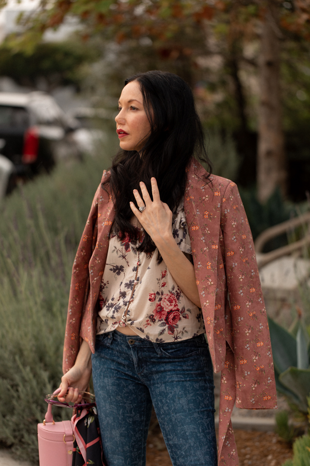 How to Style Floral Prints | Floral Prints by popular L.A. fashion blog, Pretty Little Shoppers: image of woman wearing a floral blouse, floral print jeans, Pimpinela Corduroy Jacket, and stiletto heels.  