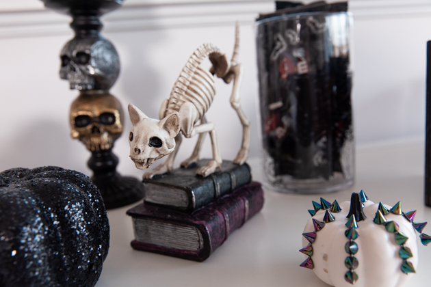  Celebrating Halloween In My New House, Halloween Ideas, How to Celebrate Halloween at Home, Halloween Ideas during Covid-19 Quarantine, Los Angeles Lifestyle Blogger, Pretty Little Shoppers Blog, Halloween Decorations #Halloween2020 |Cheese Platter by popular LA lifestyle blog, Pretty Little Shoppers: image of a skeleton cat, black glitter pumpkin, white pumpkin, and skull candle holder. 