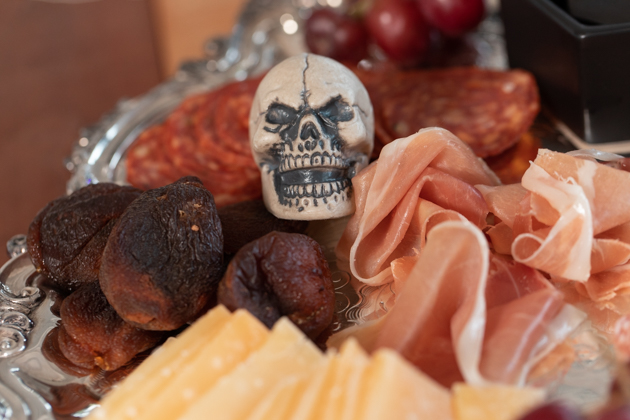 Halloween Cheese Platter and Candy Buffet, Celebrating Halloween In My New House, Halloween Ideas, How to Celebrate Halloween at Home, Halloween Ideas during Covid-19 Quarantine, Los Angeles Lifestyle Blogger, Pretty Little Shoppers Blog, Halloween Decorations #Halloween2020 #HalloweenCheesePlatter |Cheese Platter by popular LA lifestyle blog, Pretty Little Shoppers: image of a tiny skull on a meat and cheese platter. 