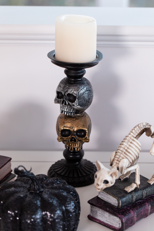 Halloween Cheese Platter and Candy Buffet, Celebrating Halloween In My New House, Halloween Ideas, How to Celebrate Halloween at Home, Halloween Ideas during Covid-19 Quarantine, Los Angeles Lifestyle Blogger, Pretty Little Shoppers Blog, Halloween Decorations #Halloween2020 |Cheese Platter by popular LA lifestyle blog, Pretty Little Shoppers: image of a skull candle holder, cat skeleton, and black glitter pumpkin. 