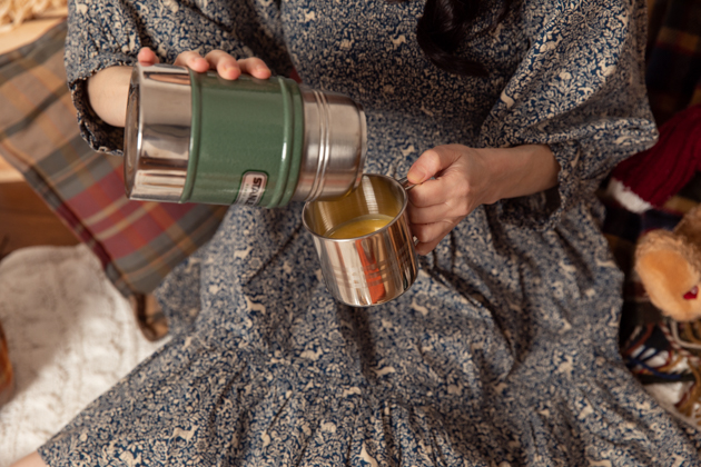 Stanley Thermos with Creamy Delicata Squash Soup |Fall Picnic by popular LA lifestyle blog, Pretty Little Shoppers: image of a woman pouring some soup from a thermos. 