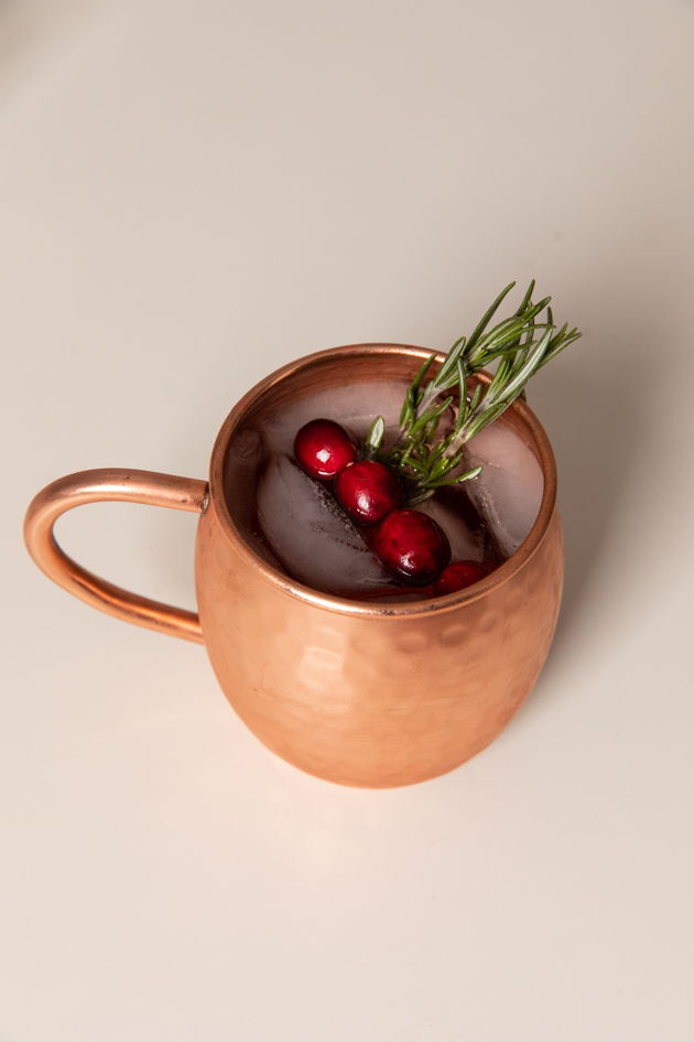 Holiday Moscow Mule, Christmas Cocktail Ideas, Thanksgiving Cocktail Ideas, Festive Holiday Drinks, Home Bar, Home Interior, How to Celebrate the Holidays at Home, Holiday Ideas During Covid Quarantine, Yule Mule, Holiday Moscow Mocktail Los Angeles Lifestyle Blogger, Pretty Little Shoppers Blog #holidaymoscowmule #yulemule #holidaymoscowmocktail | Moscow Mule Recipe by popular LA lifestyle blog, Pretty Little Shoppers: image of a Moscow Mule in a copper mug. 