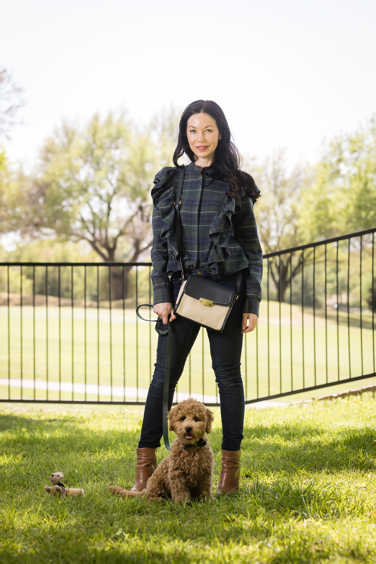 GoldenDoodle Puppy, Matching Mom and Dog Outfits, Tartan Blouse, Tartan Bowtie and Leash, Meet My New Puppy, Pretty Little Shoppers Blog, Dallas Lifestyle Blog, #GoldenDoodlePuppy #MeetMyPup | Charlie Cupcake by popular Dallas lifestyle blog, Pretty Little Shoppers: image of a woman wearing a plaid ruffle top and jeans and standing next to her goldendoodle puppy. 