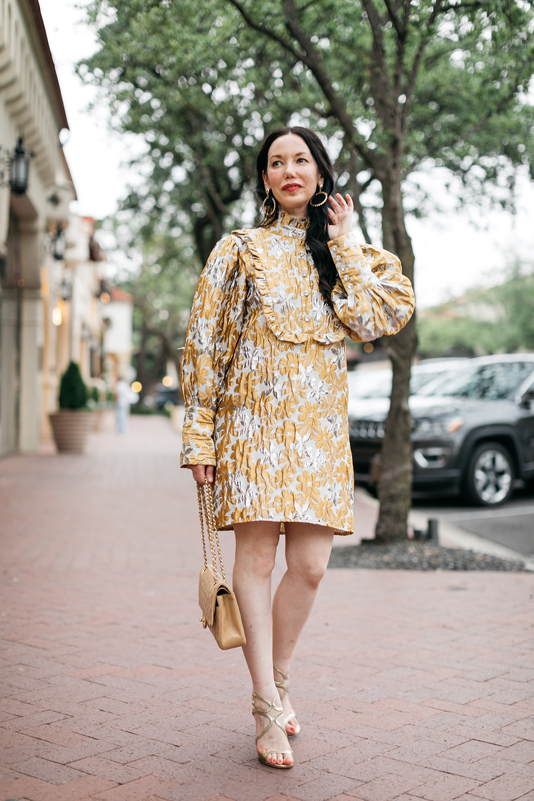 Sister Jane Cocktail Dress, Ettika Statement Earrigns | Cocktail Dress by popular Dallas fashion blog, Pretty Little Shoppers: image of a woman walking outside on a brick paved sidewalk and wearing a Sister Jane Cocktail Dress, Chanel Bag, Jimmy Choo Sandals, and Ettika earrings.
