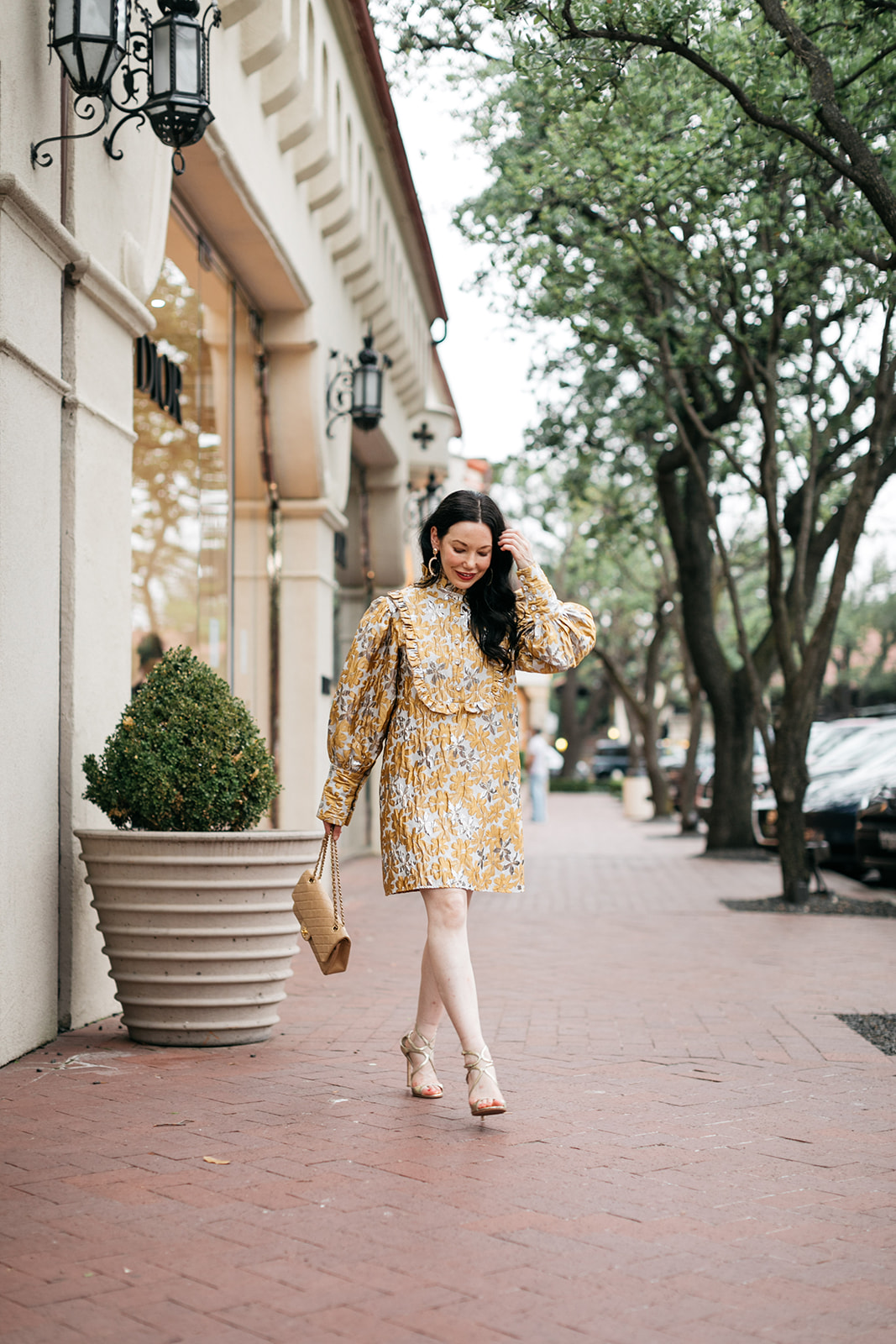 Sister Jane Cocktail Dress, Quilted Chanel Bag | Cocktail Dress by popular Dallas fashion blog, Pretty Little Shoppers: image of a woman walking outside on a brick paved sidewalk and wearing a Sister Jane Cocktail Dress, Chanel Bag, Jimmy Choo Sandals, and Ettika earrings.