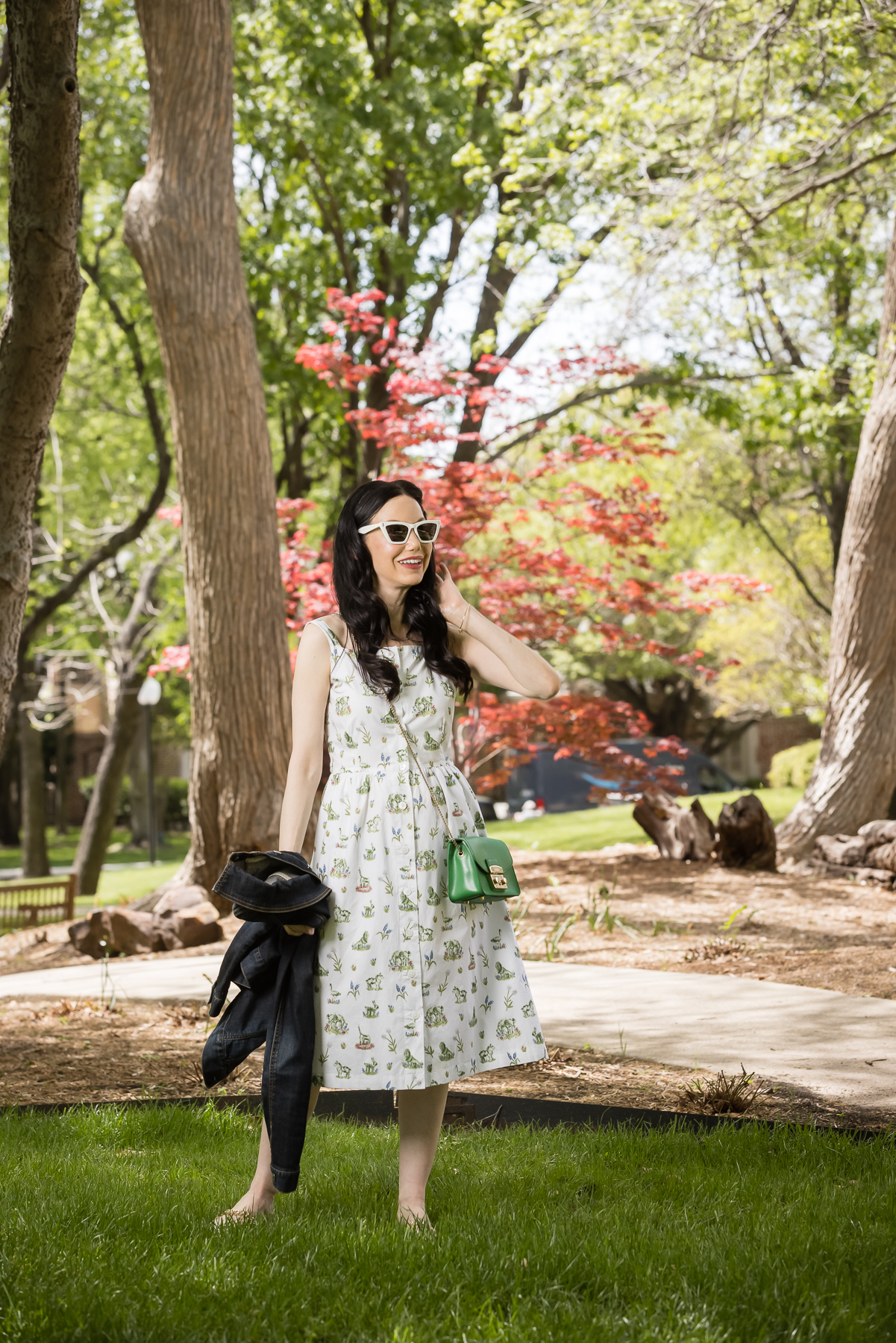 Sarah Patrick Collection Newport Topiary Gardens Dress, Green Furla Crossbody Bag |Sarah Patrick Collection by popular Dallas fashion blog, Pretty Little Shoppers: image of a woman standing outside on some grass and wearing a Sarah Patrick Collection Newport Topiary Gardens Dress with Green Furla Crossbody Bag.