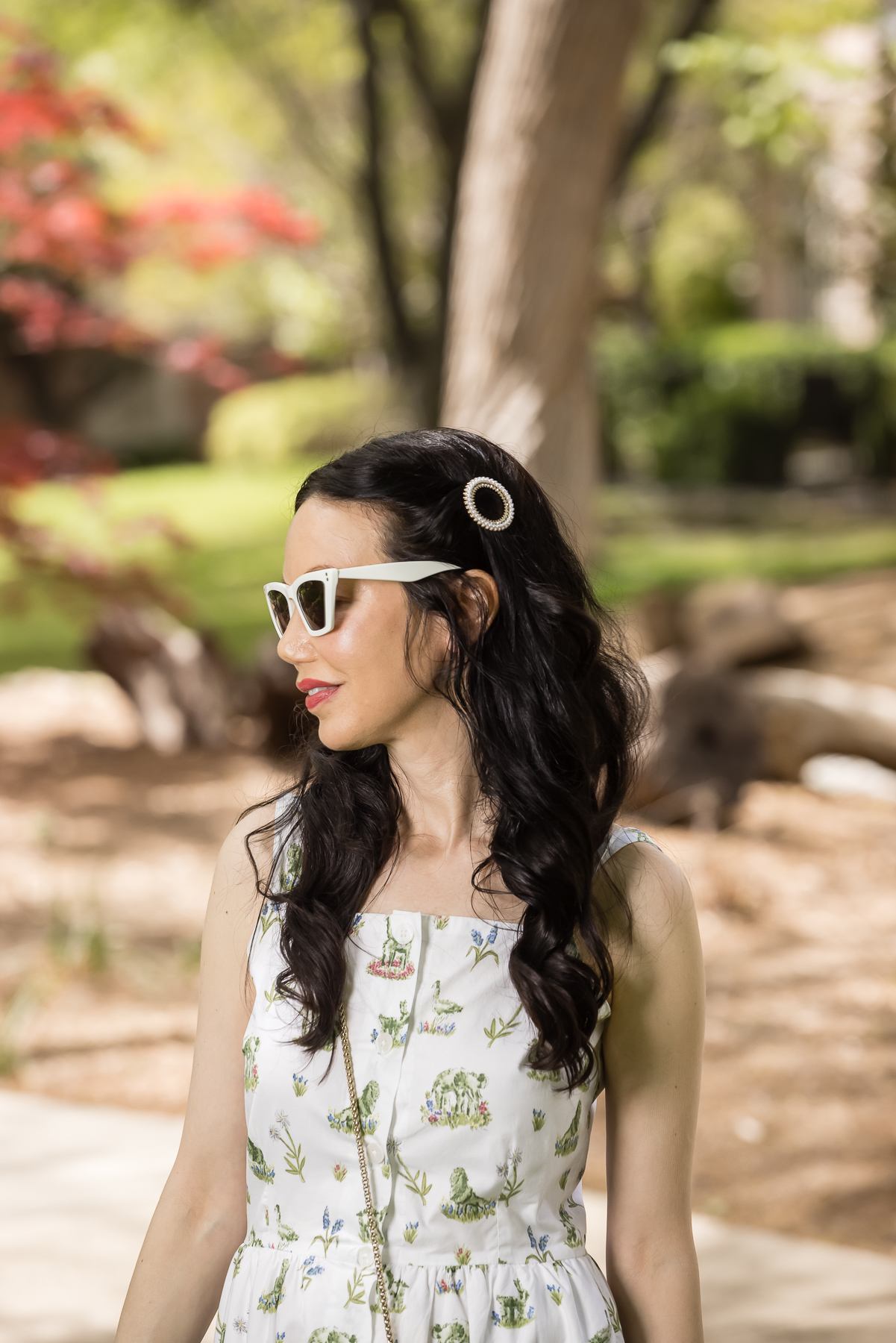 Ettika Pearl Crystal Round Ring Hair Barrette |Sarah Patrick Collection by popular Dallas fashion blog, Pretty Little Shoppers: image of a woman standing outside on some grass and wearing a Sarah Patrick Collection Newport Topiary Gardens Dress with Green Furla Crossbody Bag and round ring hair barrette.