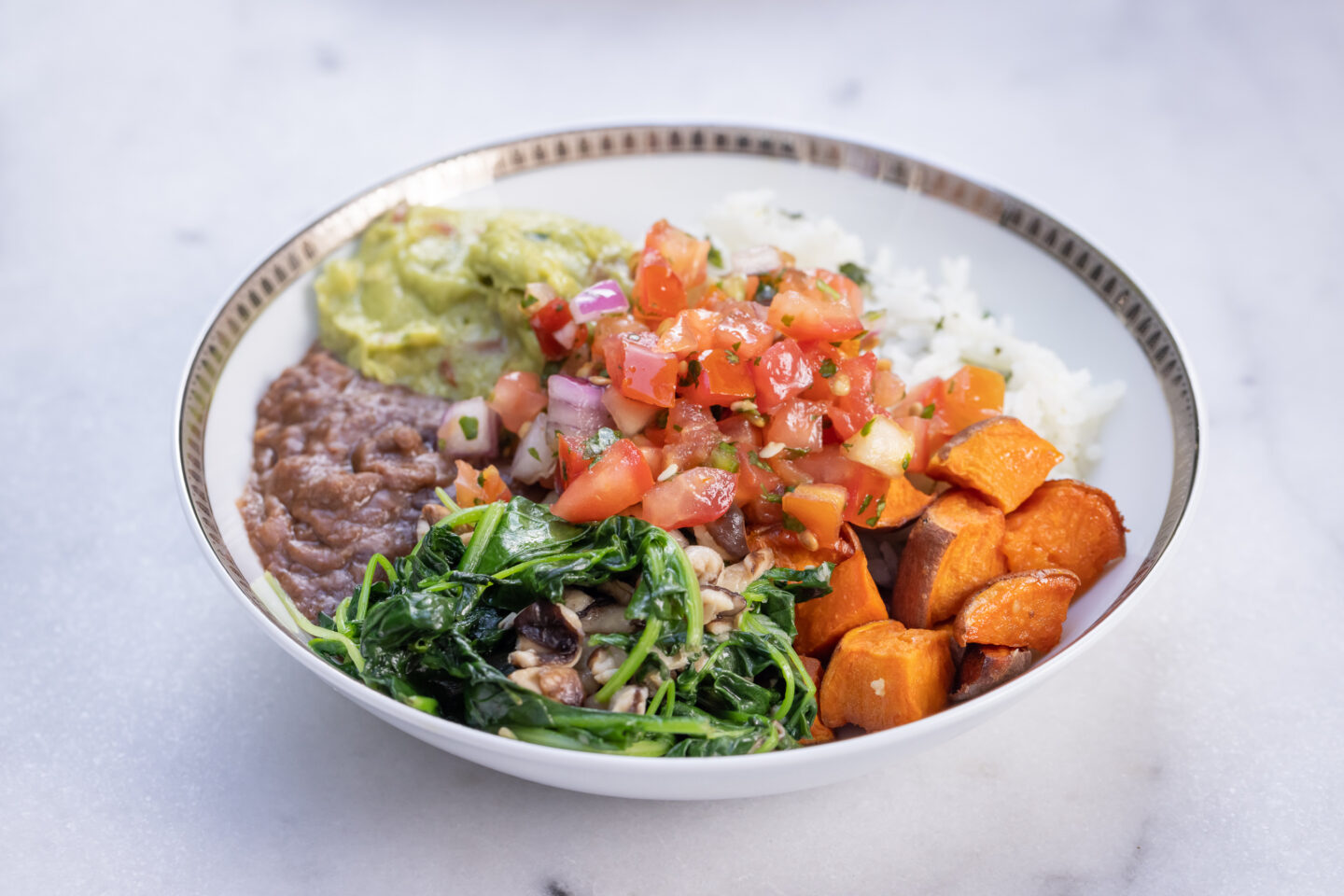 Sweet Potato, Black Bean and Cilantro Lime Rice Burrito Bowl with Sauteed Greens and Mushrooms, Pico de Gallo and Guacamole served with Siete Grain Free Chips and Salsa, Healthy Recipes, Vegan Recipes, Mexican Buddha Bowl, Gluten Free Recipes | Burrito Bowl by popular Dallas lifestyle blog, Pretty Little Shoppers: image of a sweet potato, black bean and cilantro lime rice burrito bowl. 