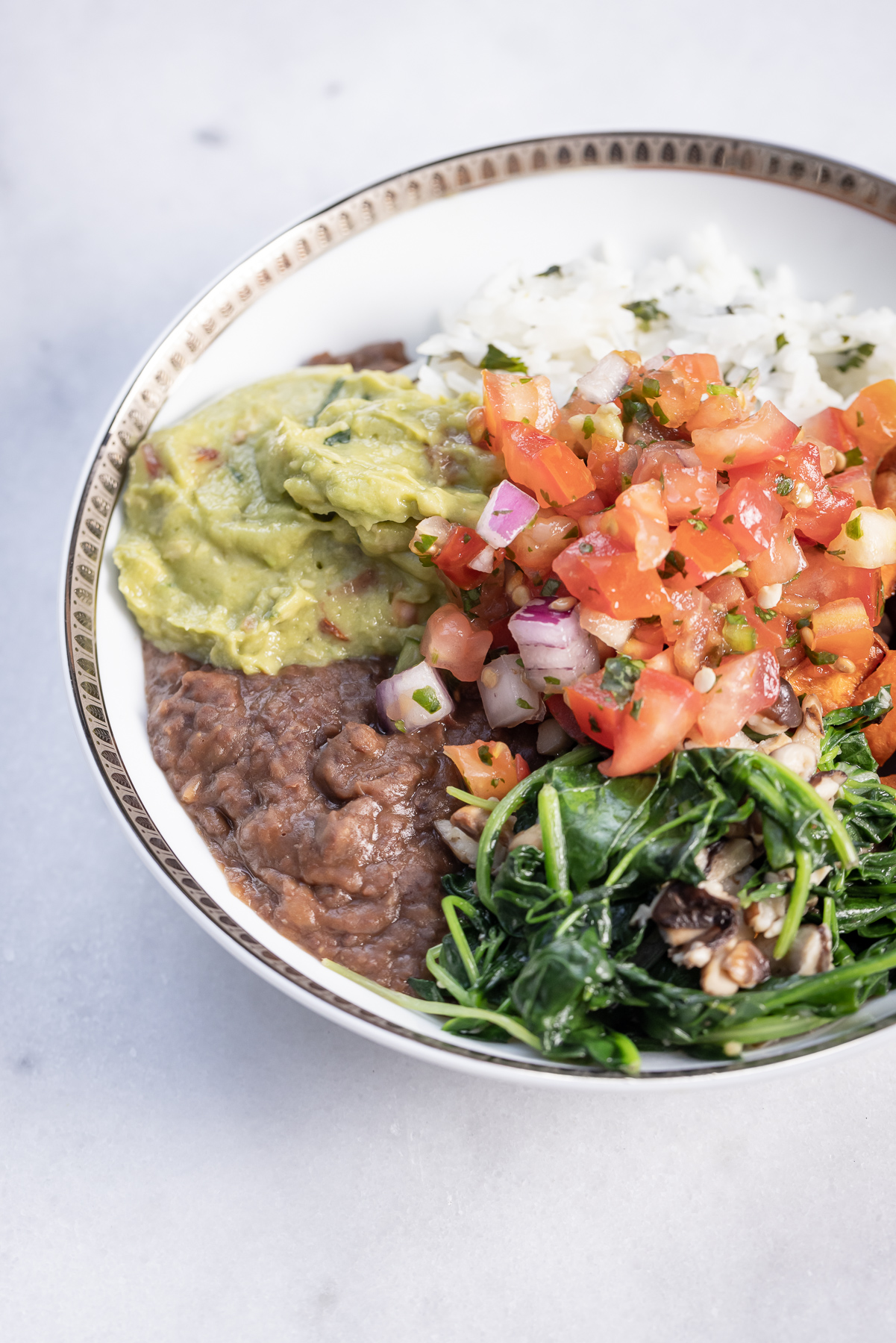 Sweet Potato, Black Bean and Cilantro Lime Rice Burrito Bowl with Sauteed Greens and Mushrooms, Pico de Gallo and Guacamole served with Siete Grain Free Chips and Salsa, Healthy Recipes, Vegan Recipes, Mexican Buddha Bowl, Gluten Free Recipes | Burrito Bowl by popular Dallas lifestyle blog, Pretty Little Shoppers: image of a sweet potato, black bean and cilantro lime rice burrito bowl.