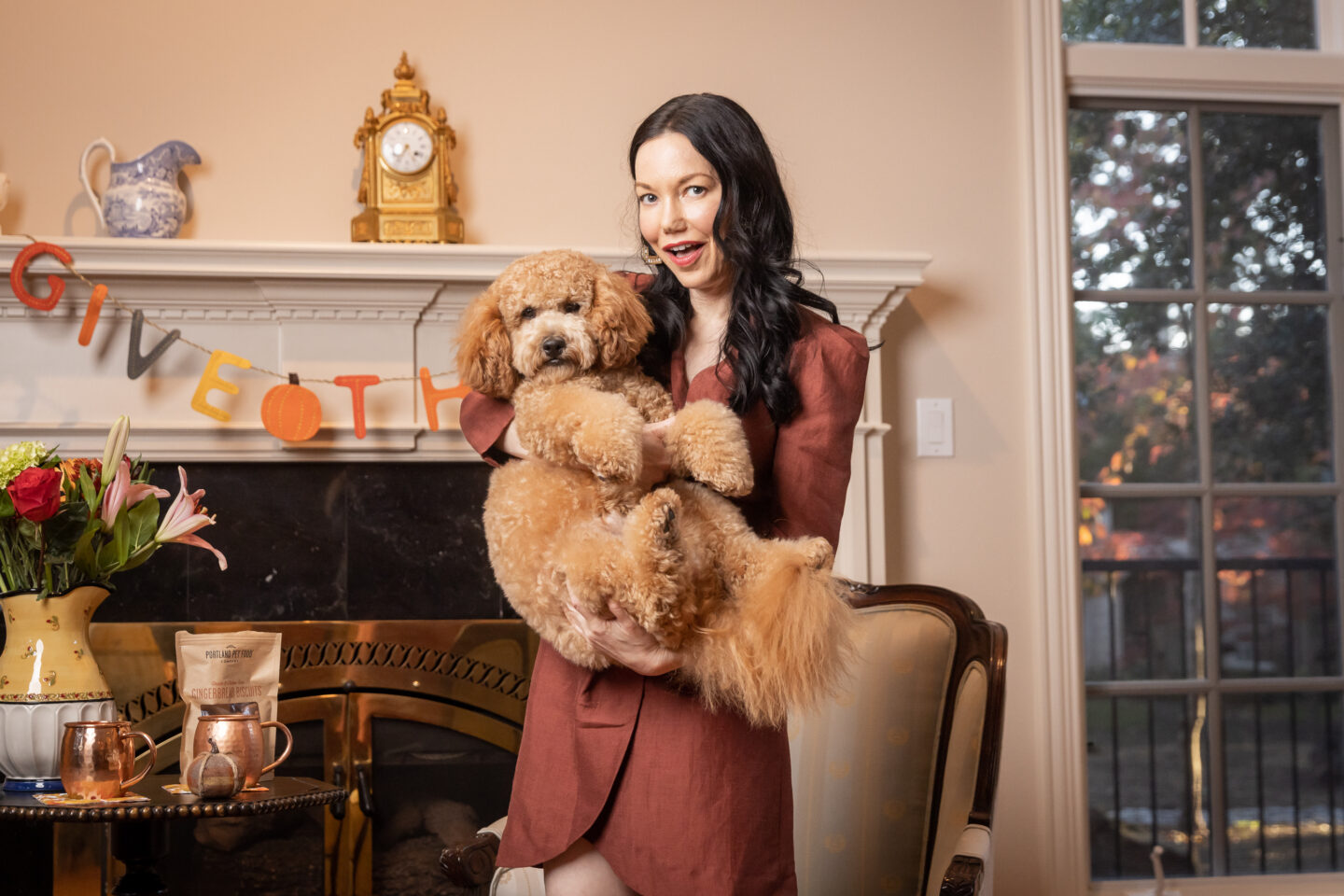 Brunette Woman holding Mini Goldendoodle Puppy